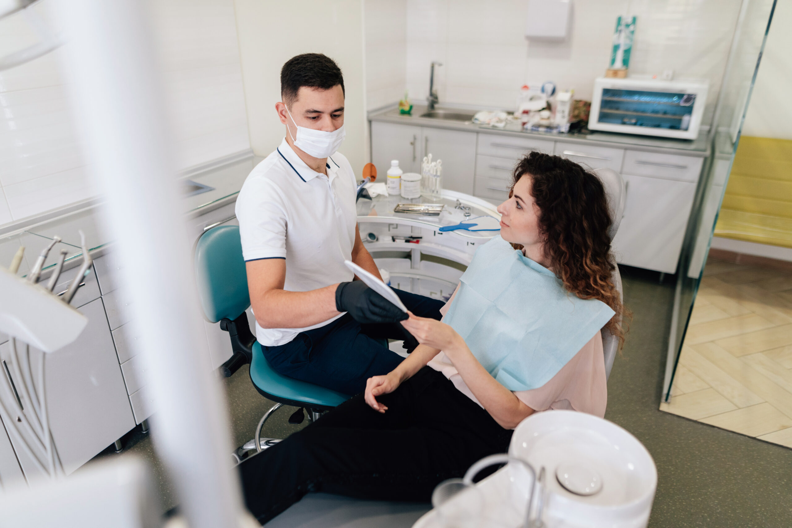 Dentist giving mirror to patient in the office