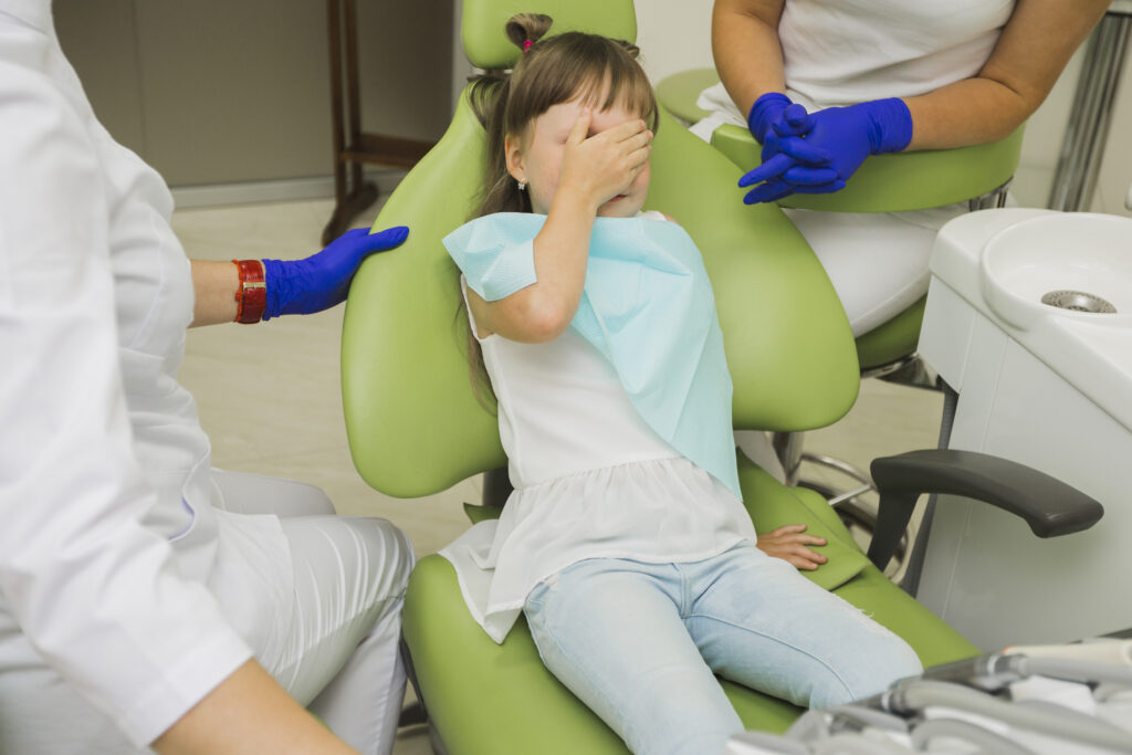 scared girl with dentist